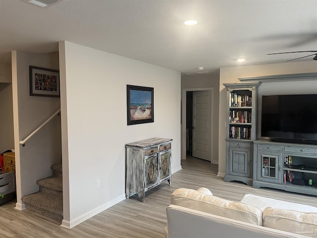 living area with light wood finished floors, stairs, baseboards, ceiling fan, and recessed lighting