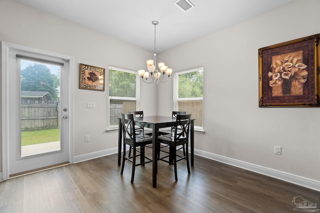 124 Polo Ter, Pensacola, FL 32534 - dining room featuring a chandelier, dark wood-type flooring, and healthy amount of natural light