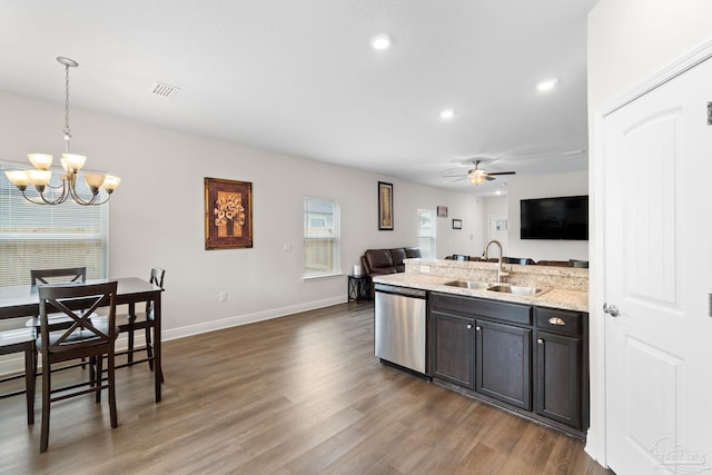 124 Polo Ter, Pensacola, FL 32534 - kitchen with stainless steel dishwasher, a sink, open floor plan, a chandelier, and a ceiling fan