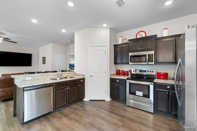 124 Polo Ter, Pensacola, FL 32534 - kitchen featuring appliances with stainless steel finishes, open floor plan, a peninsula, a sink, and wood finished floors
