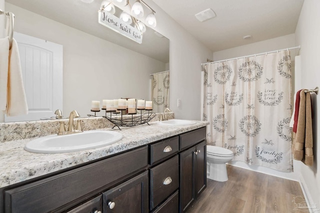 124 Polo Ter, Pensacola, FL 32534 - bathroom with wood finished floors, toilet, and double vanity