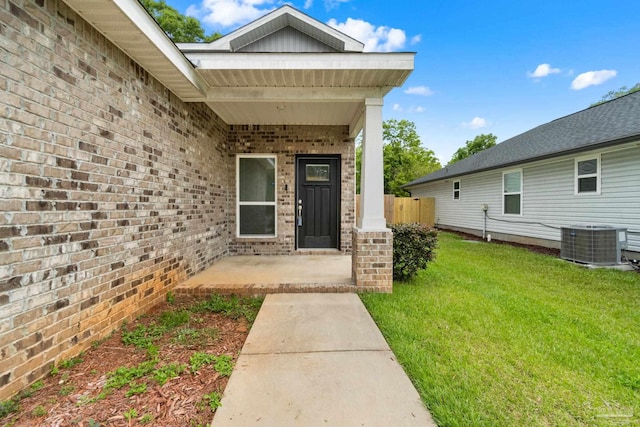 124 Polo Ter, Pensacola, FL 32534 - doorway to property with central AC, brick siding, and a patio area