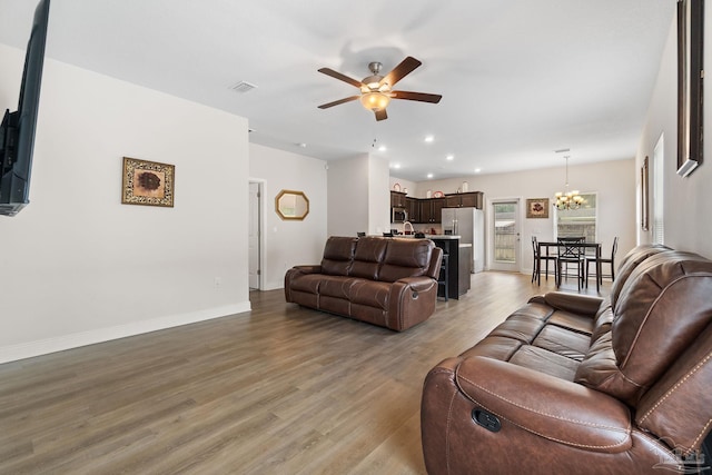 124 Polo Ter, Pensacola, FL 32534 - living room with ceiling fan, a chandelier, light wood-type flooring, baseboards, and recessed lighting