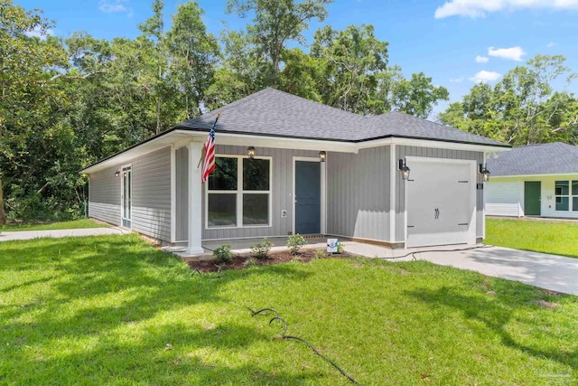 single story home featuring a garage, covered porch, and a front lawn