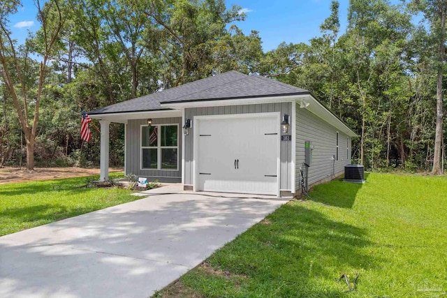 exterior space featuring a garage, a front yard, and central AC unit