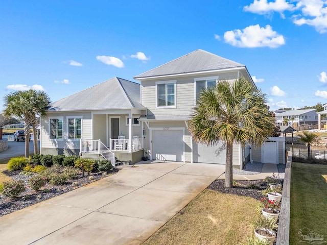 view of front of home with covered porch, a garage, and a front yard