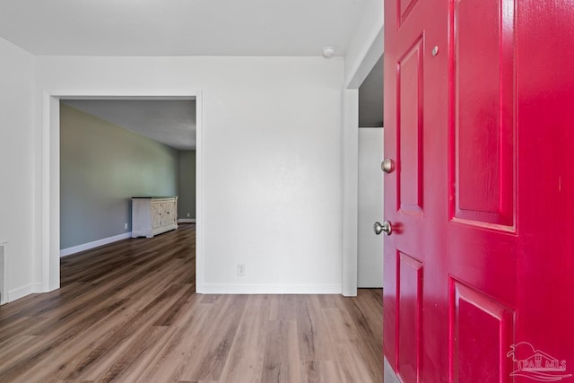 interior space with visible vents, wood finished floors, and baseboards