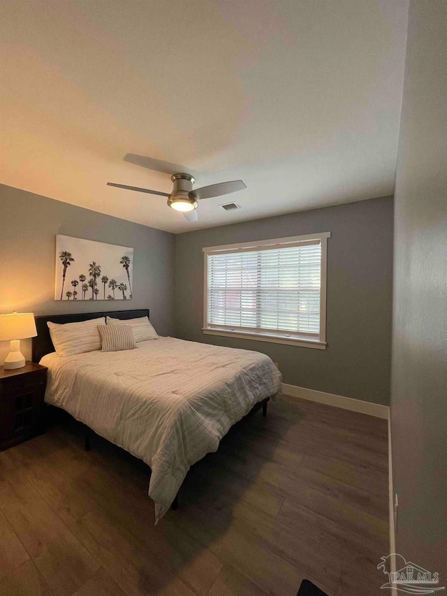 bedroom featuring dark hardwood / wood-style floors and ceiling fan