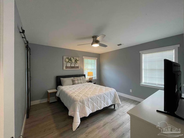 bedroom with ceiling fan and hardwood / wood-style floors