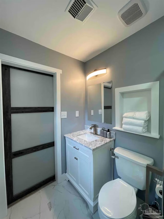 bathroom with vanity and toilet