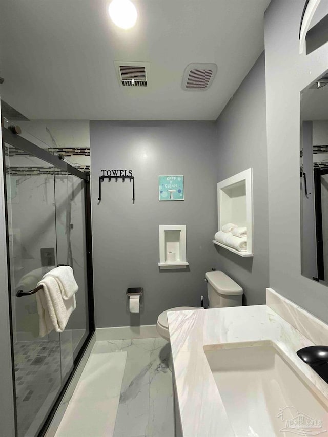 bathroom with walk in shower, vanity, and toilet