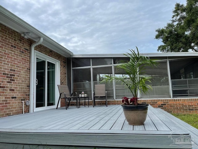 wooden terrace featuring a sunroom