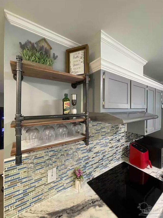 interior space featuring ornamental molding and backsplash