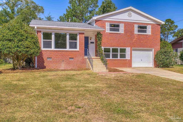 tri-level home with a garage and a front lawn