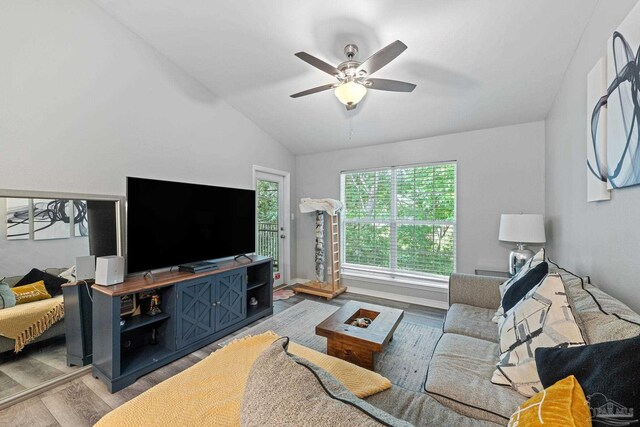 living area featuring wood finished floors, a ceiling fan, and lofted ceiling