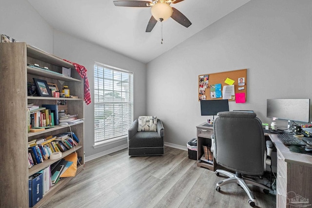 office area featuring vaulted ceiling, wood finished floors, ceiling fan, and baseboards