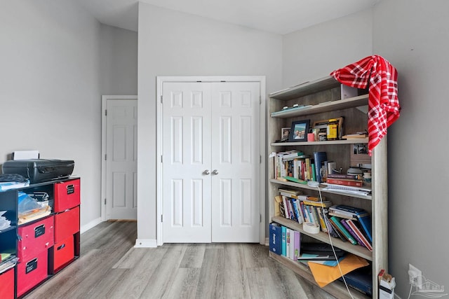 recreation room featuring wood finished floors and baseboards
