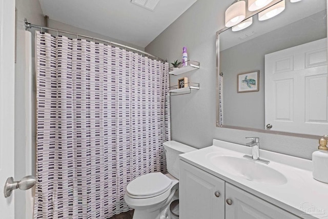 full bathroom with toilet, vanity, and a shower with curtain