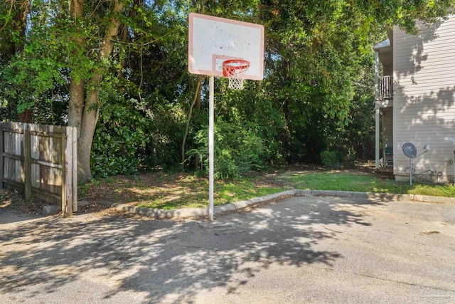 view of sport court featuring fence