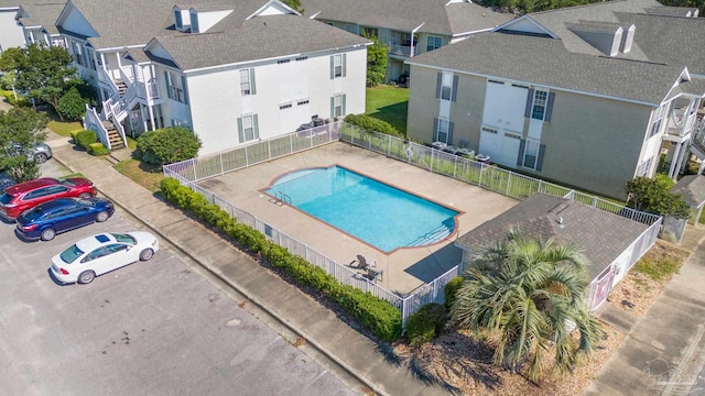 community pool with fence and a residential view