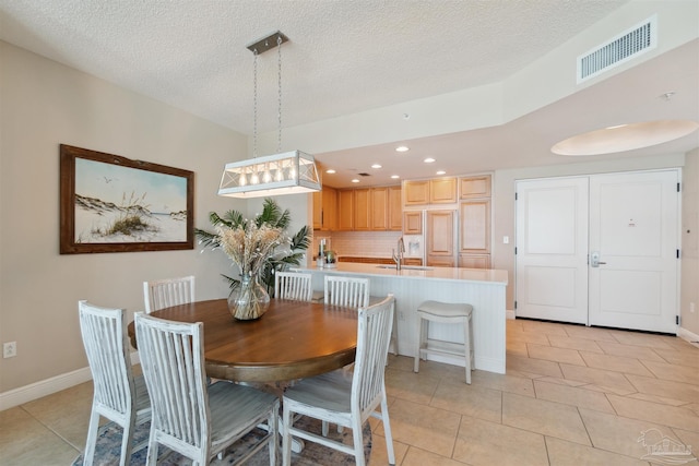 dining area with recessed lighting, a textured ceiling, visible vents, and light tile patterned floors