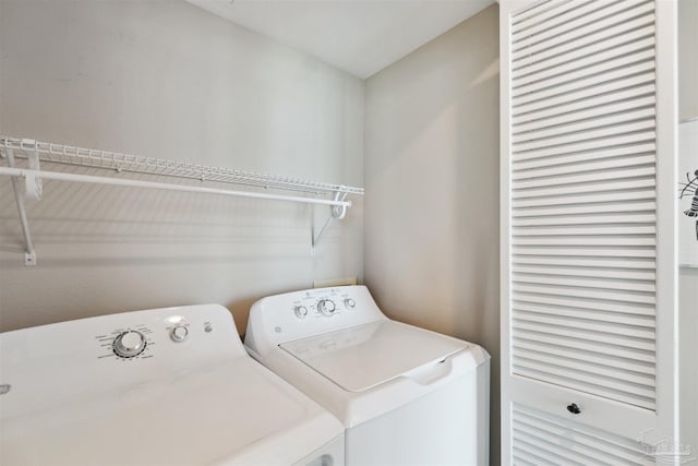 washroom featuring washer and clothes dryer and laundry area