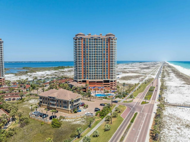 drone / aerial view featuring a beach view and a water view