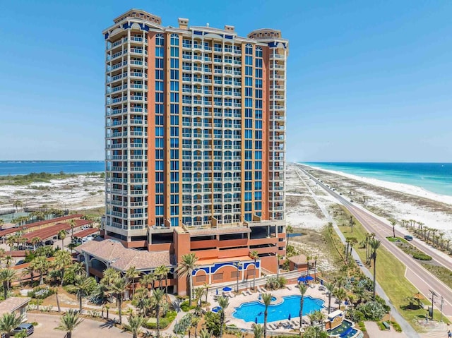 view of building exterior with a view of the beach and a water view