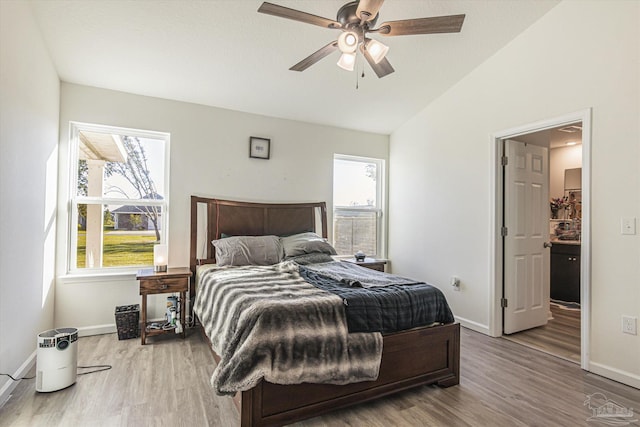 bedroom with lofted ceiling, hardwood / wood-style floors, and ceiling fan