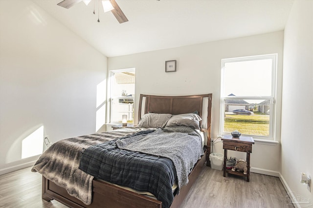 bedroom featuring vaulted ceiling, light wood-type flooring, and ceiling fan