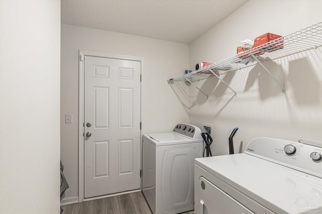 clothes washing area featuring washer and dryer and dark hardwood / wood-style floors