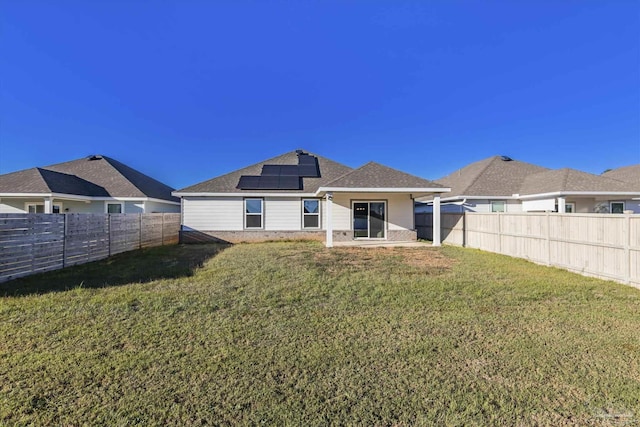 rear view of house with a yard