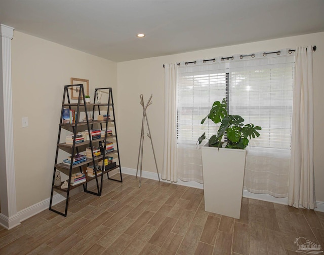 interior space featuring recessed lighting, baseboards, and wood finished floors