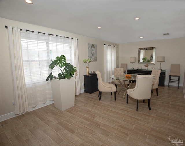dining area with recessed lighting, baseboards, visible vents, and light wood-style flooring