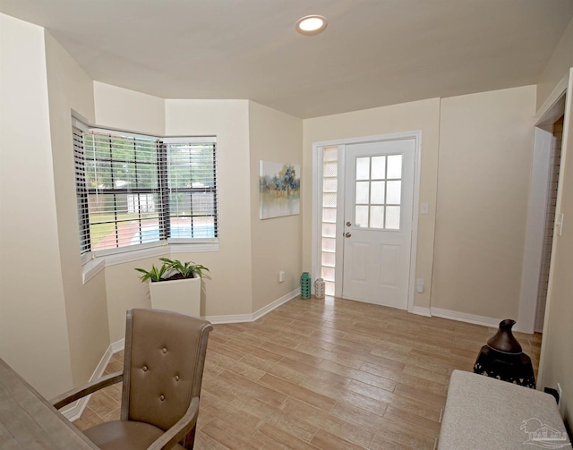foyer featuring light wood-type flooring, recessed lighting, and baseboards