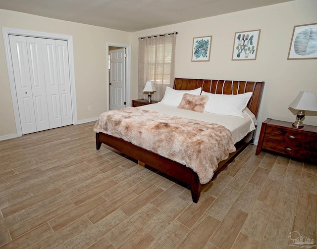 bedroom featuring a closet, baseboards, and light wood-type flooring