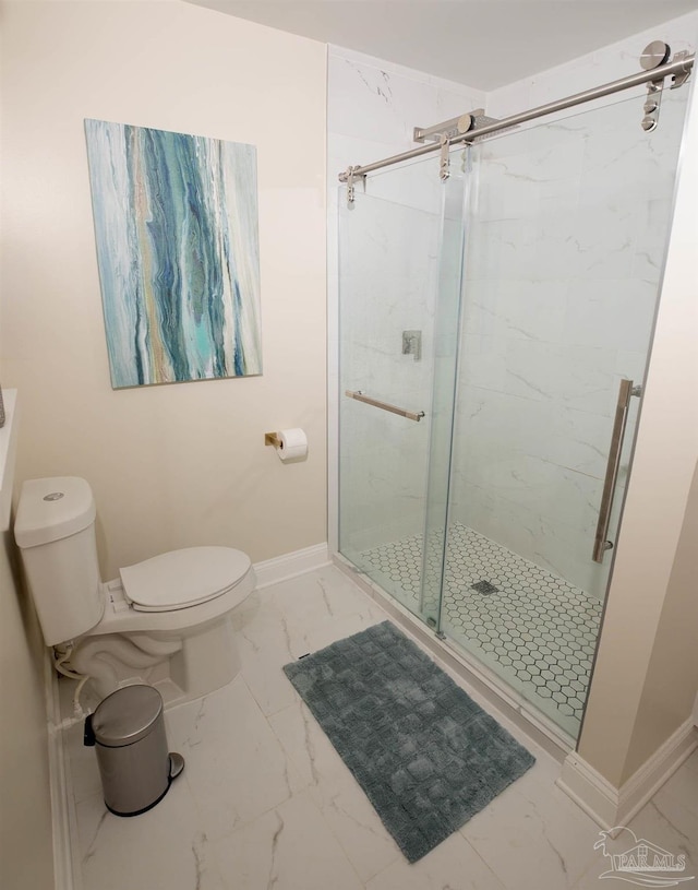 bathroom featuring baseboards, marble finish floor, a marble finish shower, and toilet