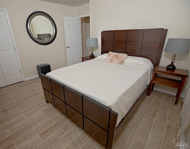 bedroom with wood tiled floor and baseboards