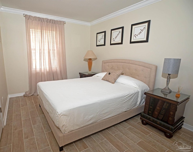 bedroom featuring baseboards, crown molding, and wood finish floors