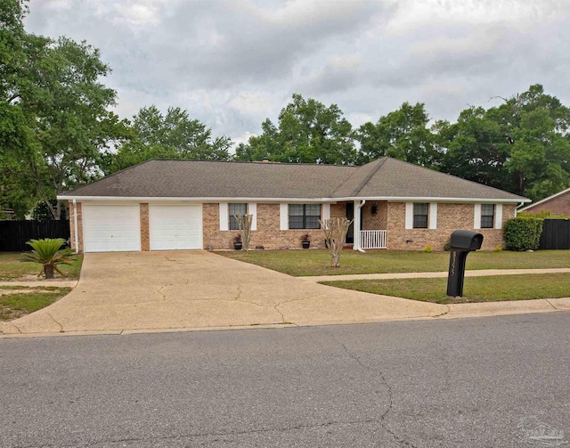 ranch-style house with concrete driveway, a garage, fence, and a front lawn