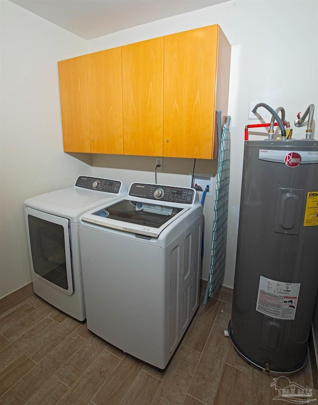 clothes washing area featuring cabinet space, water heater, washing machine and dryer, and dark wood-style floors