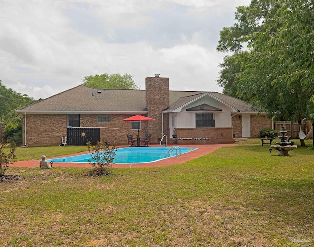 view of swimming pool with a fenced in pool, fence, and a yard