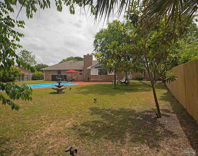 view of yard with a fenced in pool and a fenced backyard