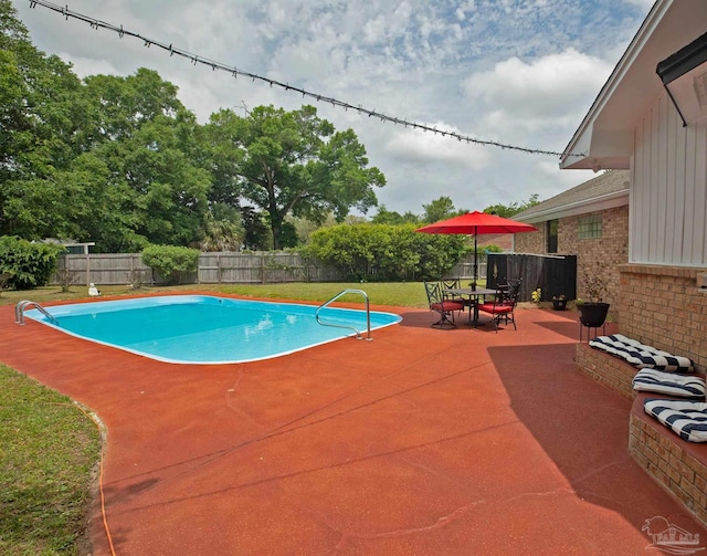 view of swimming pool featuring a fenced in pool, a lawn, a fenced backyard, and a patio area