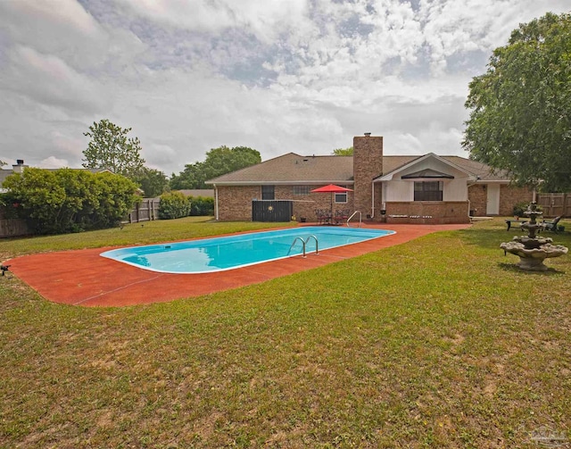 view of swimming pool featuring a fenced backyard, a fenced in pool, a patio, and a lawn