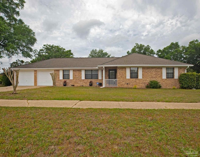single story home featuring concrete driveway, brick siding, an attached garage, and a front lawn