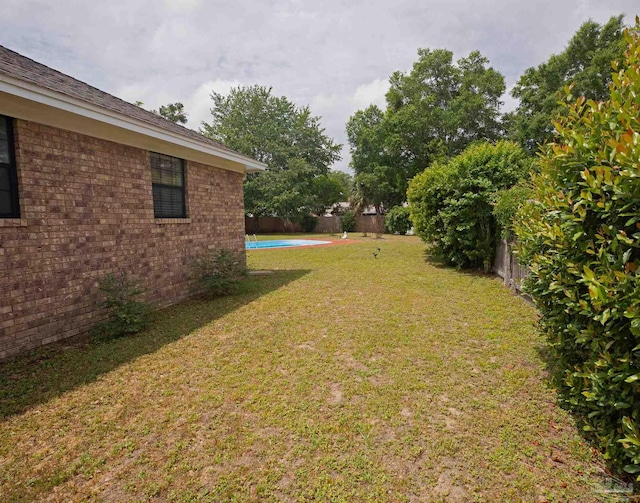 view of yard with a fenced in pool and a fenced backyard