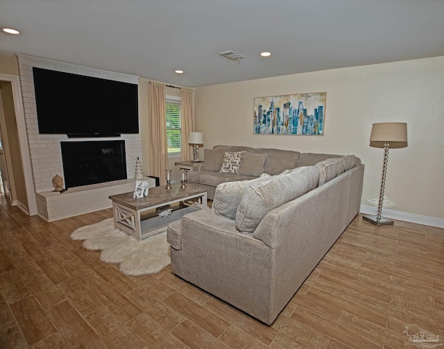 living area with baseboards, recessed lighting, and wood finished floors