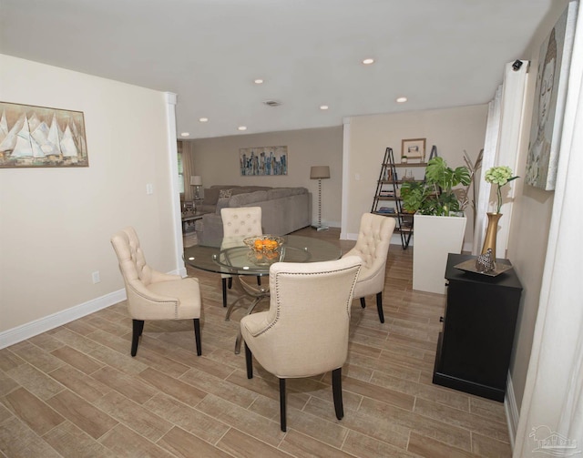 dining area featuring light wood-style floors, baseboards, and recessed lighting