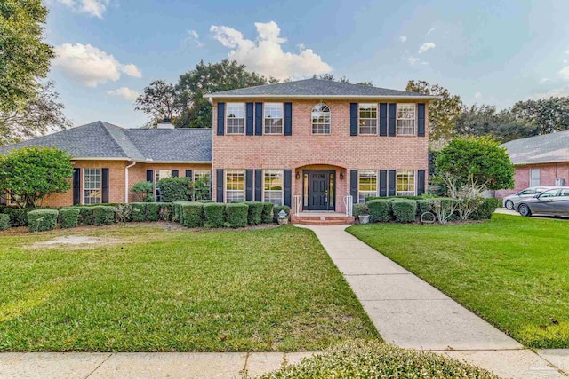 colonial home with a front lawn